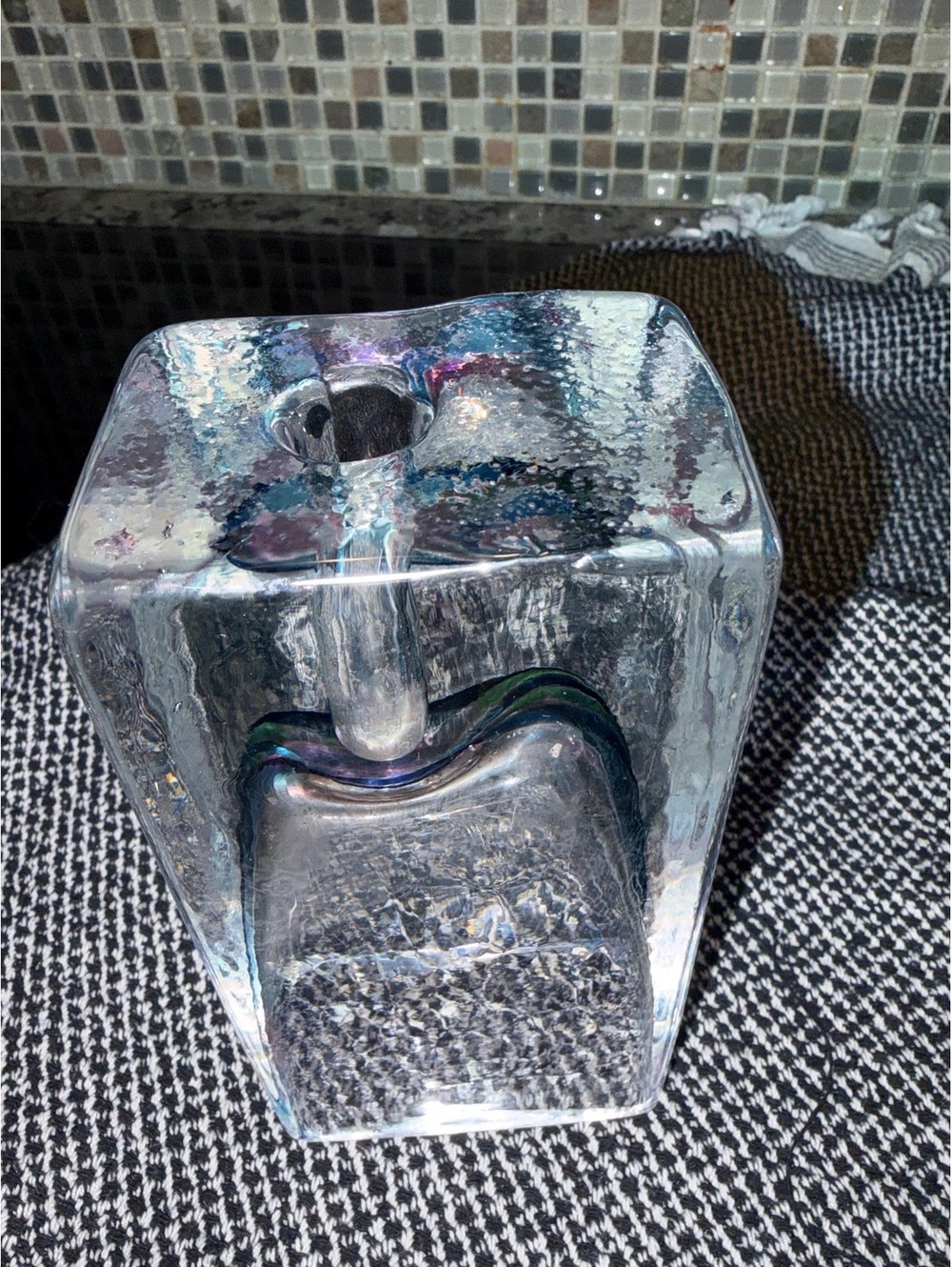 This is a vintage mouth-blown hammered hexagonal art glass vase.